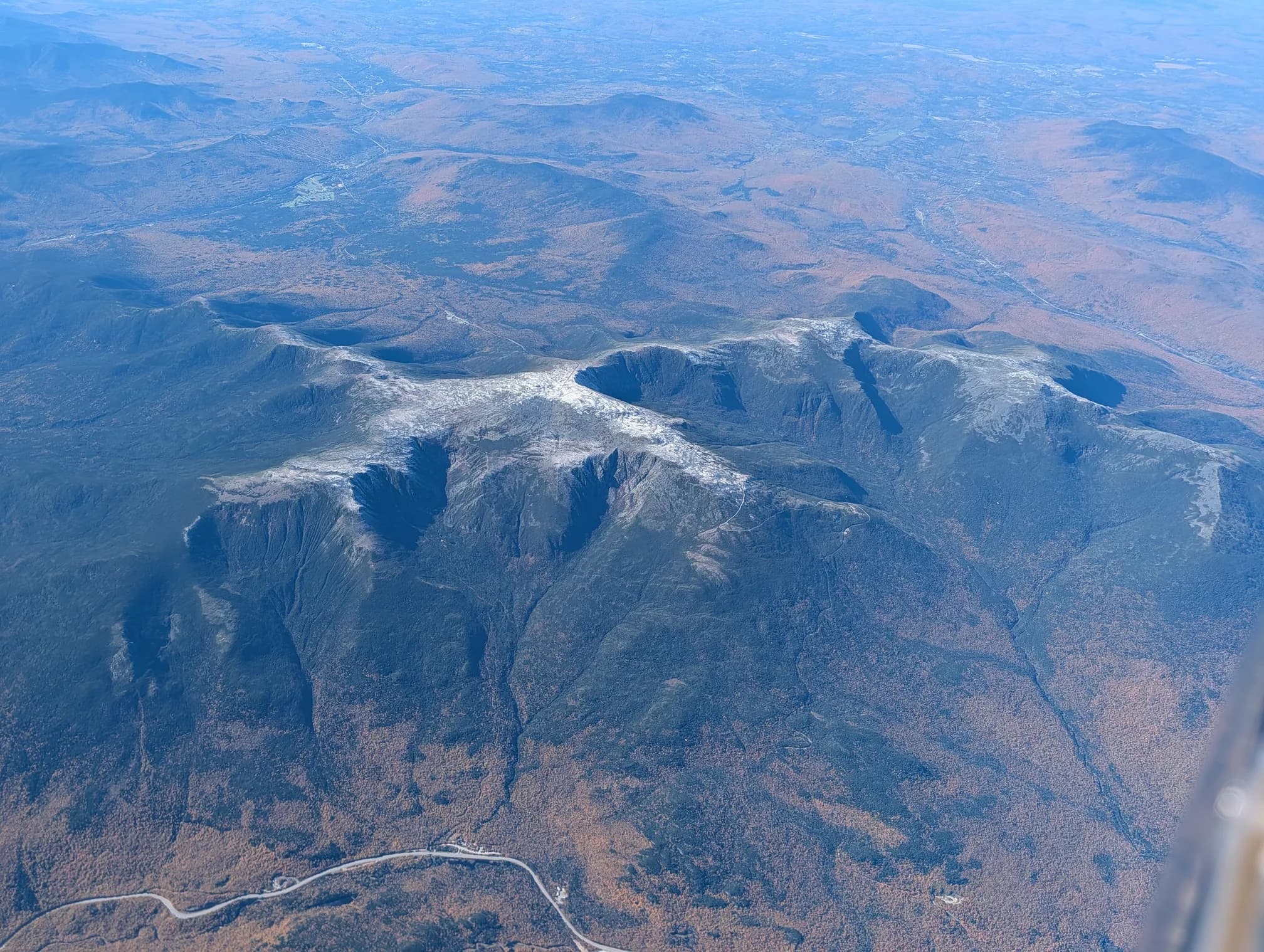 The snow-dusted Presidential Range seen from the air, fall color in the valleys below