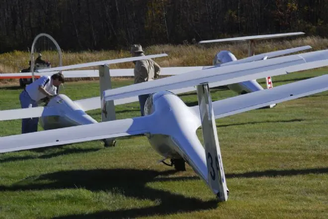 Pilots preparing gliders on the grass at Gorham