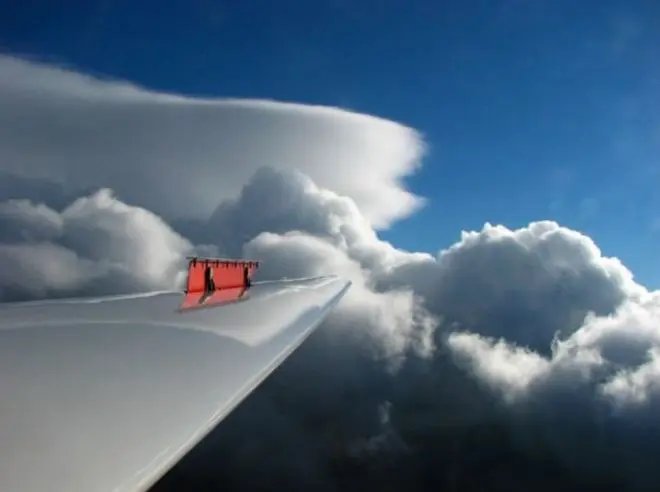 A lenticular cloud seen past the wing of a glider